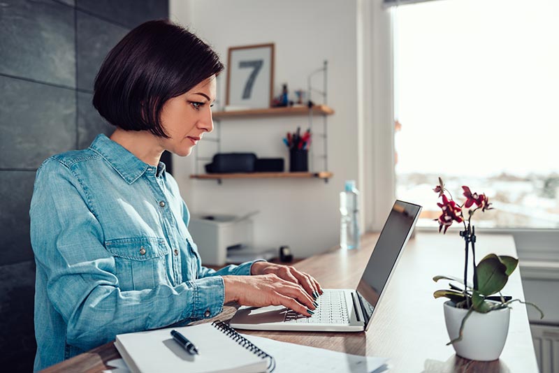 Sit-stand desk with woman at work